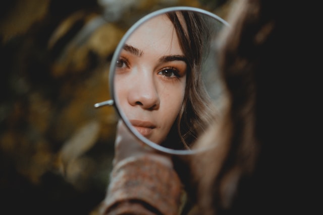 Girl looking into mirror
